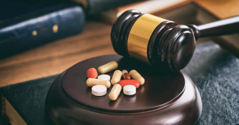 Law gavel and colorful pills Healthcare Fraud